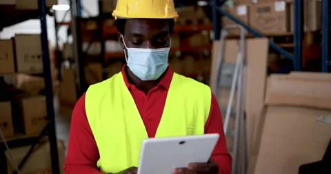 African worker using tablet inside warehouse Stock Footage 145427743