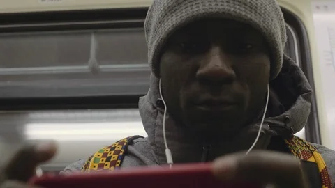 African young man active playing on the phone listening to music Stock Footage 102438018