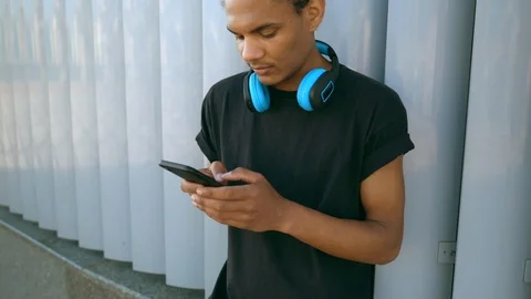 African young man using smartphone outdoors Stock Footage 112931989