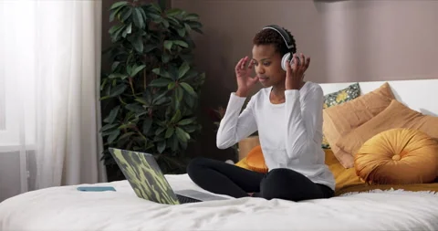 Afro amercan dark skinned freelancer sitting on bed opening laptop finishing Stock Footage 263517878