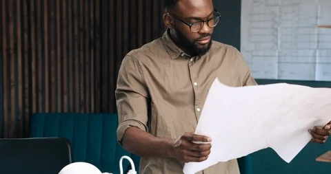 Afro-American architect working in office with blueprints. Vídeo Stock 126235536