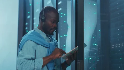 Afro-american data engineer support specialist working with digital tablet at Video stock 119783280