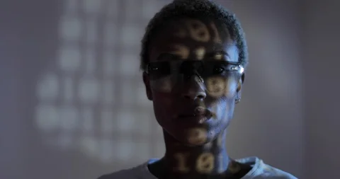 Afro American female programmer with smart glasses looking at coding Stock Footage 104195781