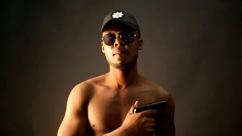 Afro american guy in a cap and glasses depicts a policeman Stock Footage 87091742