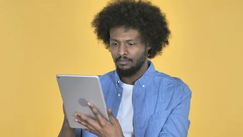 Afro-American Man Browsing Internet, Using Tablet Video stock 99223004