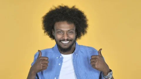 Afro-American Man Gesturing Thumbs Up on Yellow Background Video stock 99216767