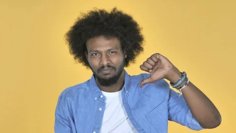 Afro-American Man Gesturing Thumbs Down on Yellow Background Stock-Footage 99217159