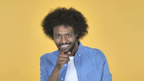 Afro-American Man Pointing at Camera on Yellow Background Video stock 99221444