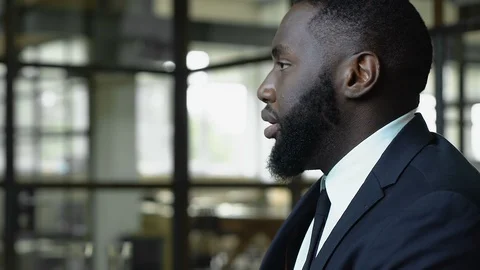 Afro-american man worrying about dismissal, racial discrimination at work 스톡 동영상 112665404