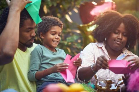 Afro-american mom and dad  playing with their son at birthday party. parentin Stock Photos
