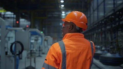Afro american supervisor walking huge modern energy production factory back view Stock Footage 182352616