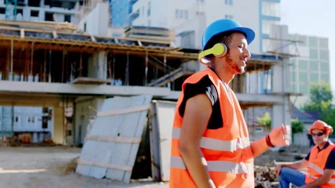 Afro American worker at construction site dancing charismatic while have a break Stock Footage 146604690