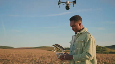 Afro-american young farm engineer with tablet computer monitoring condition of Stock Footage 162976706