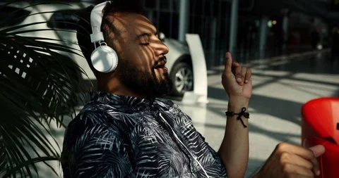 Afro american young man with beard wearing headphones and smartphone in his Stock Footage 127462687
