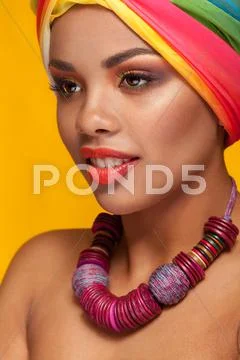 Afro american young woman wearing a turban and necklace Stock Photos
