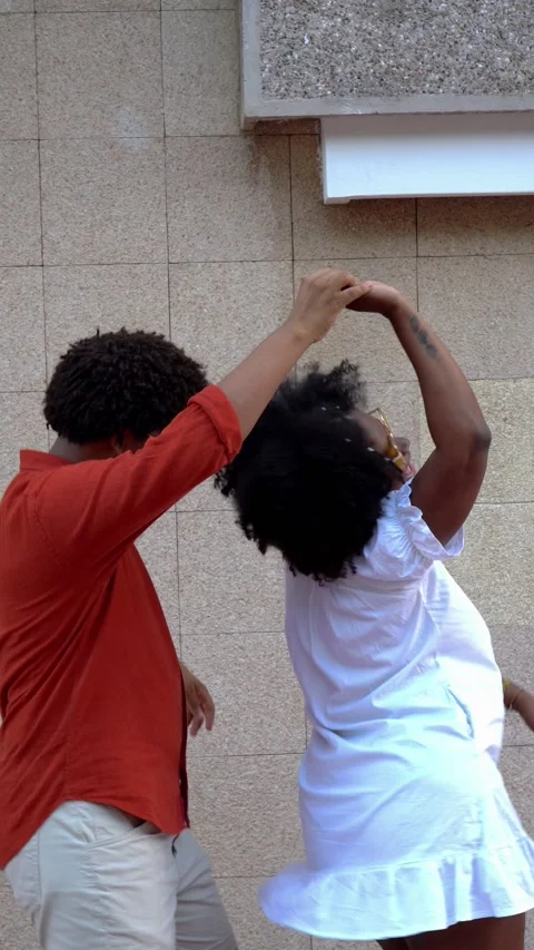 Afro couple dancing in the street Stock Footage 228117322