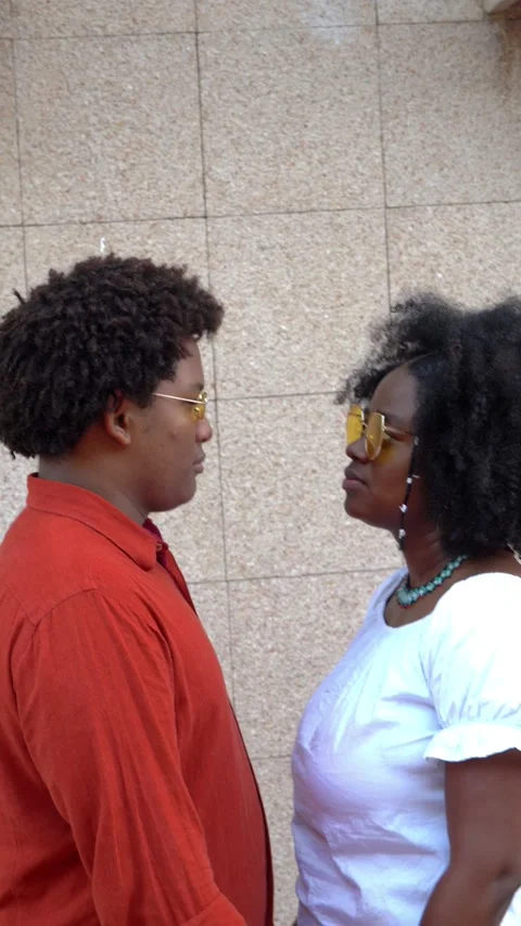 Afro couple looking at each other in the street Stock Footage 228117284