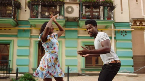 Afro dancers moving in dance outdoors. African couple dancing on street Stock Footage 144659232