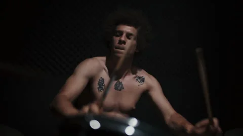 Afro Drummer Playing the Drums in a dark place Vídeo Stock 258339548