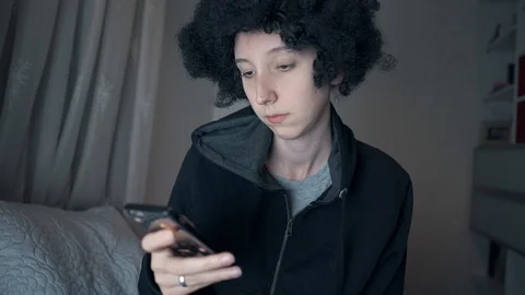 Afro haired white girl e mailed, chat with her smart phone Stock Footage 108249859