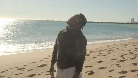 Afro man with dreadlocks doing stretching on the beach. Stock Footage 146951769