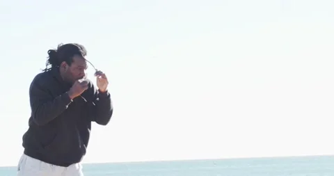 Afro man with dreadlocks throwing a punch while training martial arts Stock Footage 146951739