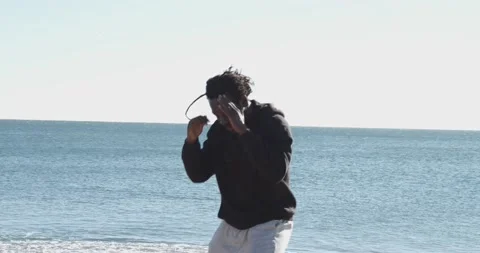 Afro man with dreadlocks training martial arts on a beach. Stock Footage 146951828