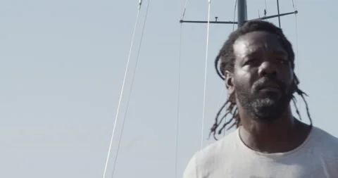 Afro man with dreadlocks trains a group of athletes in the street Stock Footage 143499248