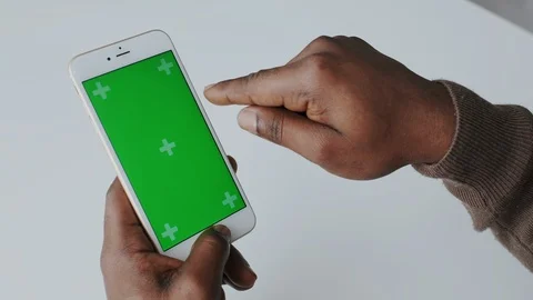 Afro Man with Greenscreen or Mock-up Tracking. Vertical Mobile Touch pad with Stock Footage 120680542