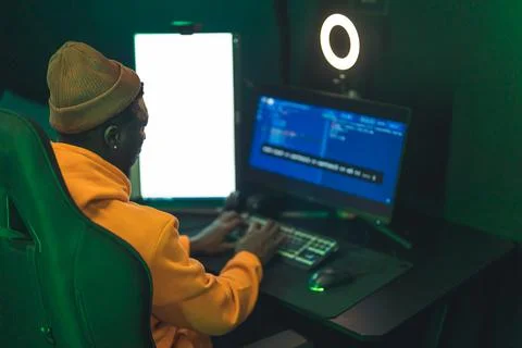 Afro man programming website firewall with codes on computer medium shot indoors Stock Photos