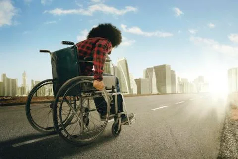 Afro man walking with wheelchair in the highway Stock Photos