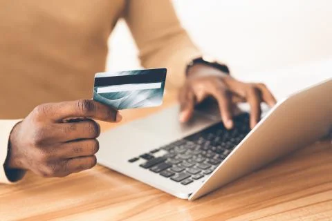 Afro manager making purchases using laptop computer 스톡 사진