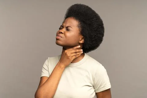 Afro woman having sore throat, tonsillitis, suffering from painful swallowing Stock Photos