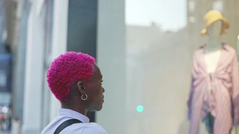 Afro woman looking in a shop window Stock Footage 200928362