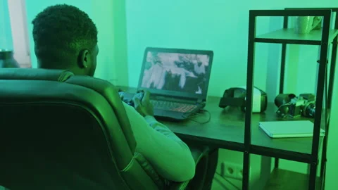 Afroamerican man playing on computer game pad - over shoulder shot Stock Footage 171893004