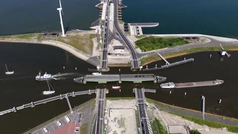 Afsluitdijk dyke with open locks allowing boats to pass in the netherlands Stock Footage 337778953