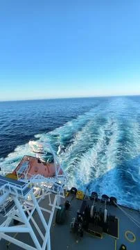 AFT SIDE VIEW OF A CARGO SHIP WHILE MOVING IN THE SEA. Stock Photos