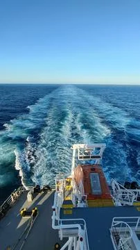 AFT SIDE VIEW OF A CARGO SHIP WHILE MOVING IN THE SEA. Stock Photos
