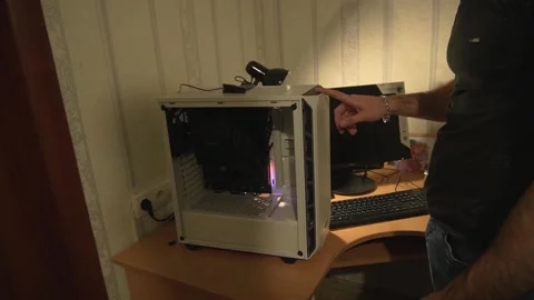 After assembling the system unit, computer case, the guy cannot start the system Stock Footage 180174962
