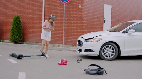 After being hit by a car in an intersection, a young woman calls the ambulance Stock Footage 248175349