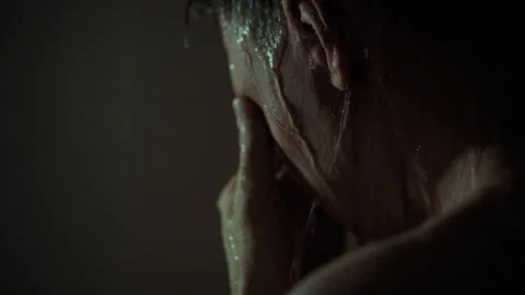 After a busy day at work a man takes a shower in a cozy bathroom. Water from Stock Footage 323726565