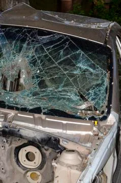 After the car crash, windshield fall on the road surface. Stock Photos