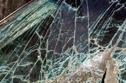 After the car crash, windshield fall on the road surface. Stock Photos