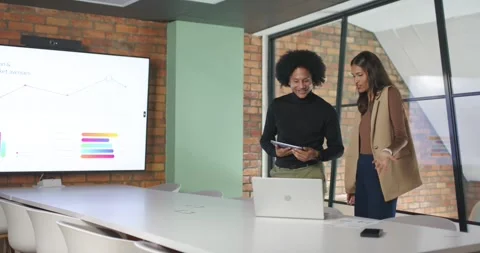 After chart update African American team reviewing tablet pointing and Stock Footage 341079591