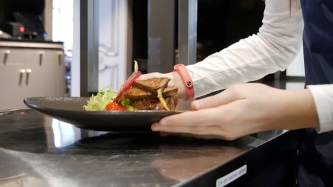 After the chef has prepared a meal, the officer brings it to the guests Stock Footage 86728492