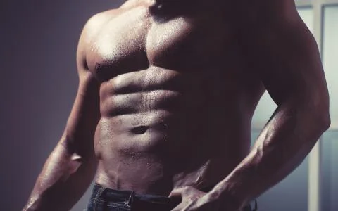 After coaching poses in front of the camera. Abdominal muscles, biceps triceps. Stock Photos