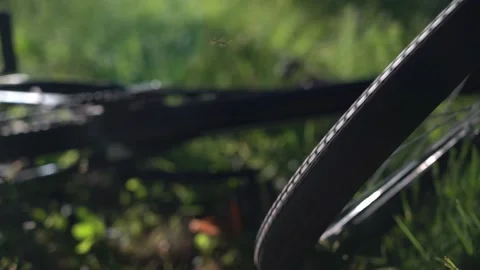 After falling from the bike. Accident while cycling. Mountain bike wheel rotates Stock Footage 135725671