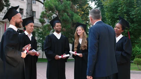 After the graduation group of multiracial students have a conversation with the Stock Footage 170080072