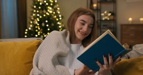 After hard day's work, lonely young girl decided to read book. She sat down on Stock Footage 211786054