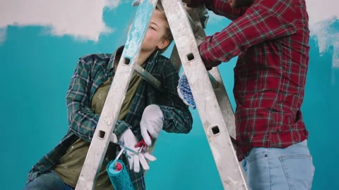 After a hard work couple make a break they painting walls at home in living room Video stock 171225085